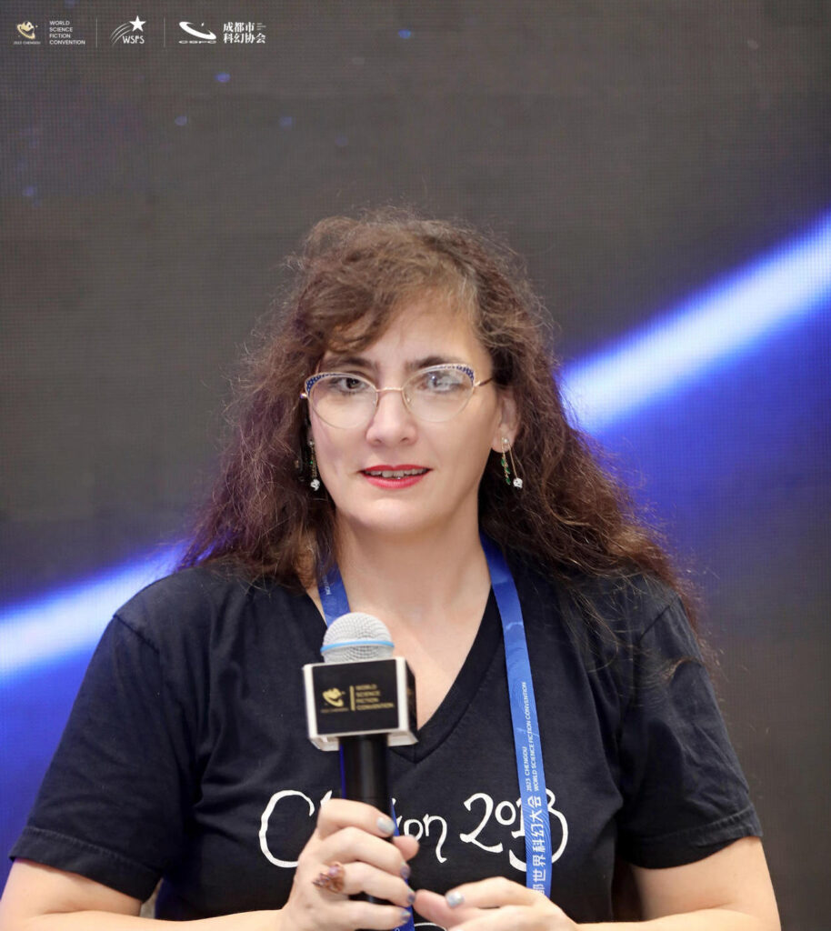 Woman with microphone in front of plain background